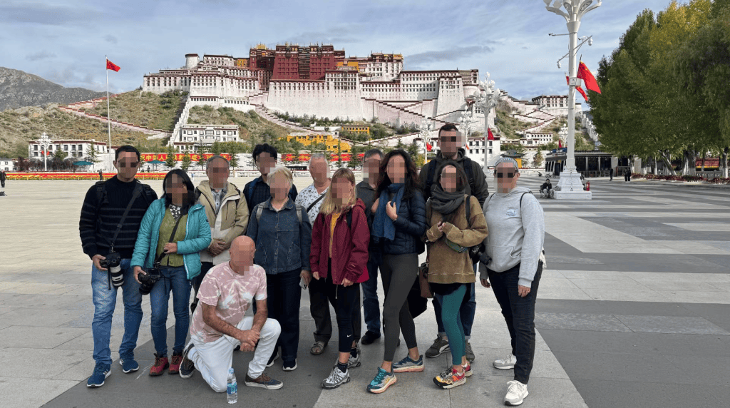 Traveler photo moment near Potala Palace in Lhasa with the palace in the background