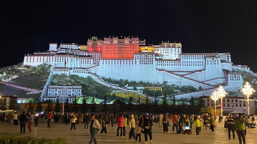 Traveler photo moment near Potala Palace in Lhasa with the palace in the background