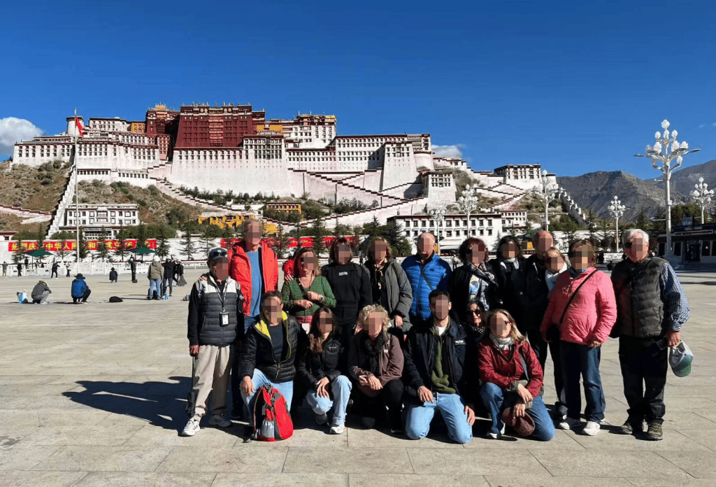 Traveler photo moment near Potala Palace in Lhasa with the palace in the background