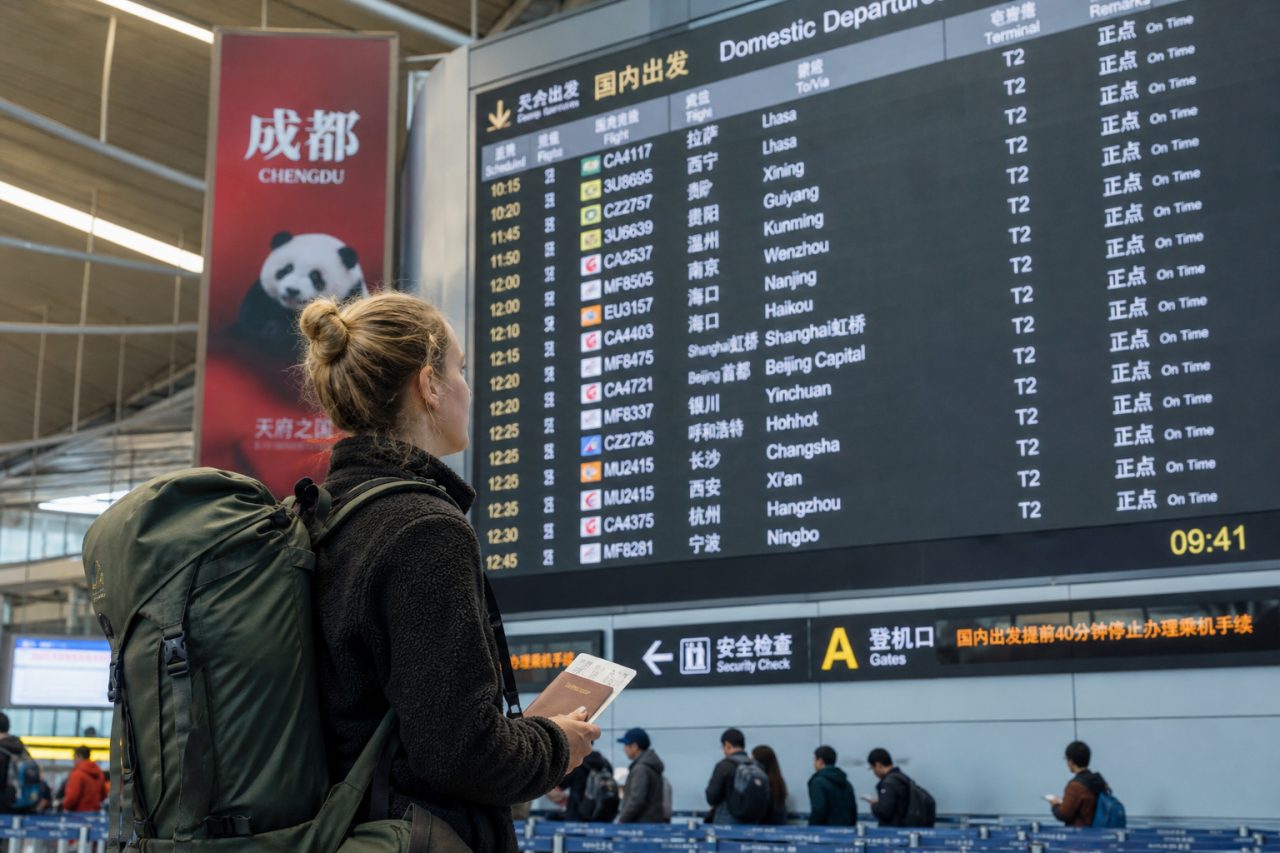 Traveler checking departures in Chengdu before flying to Tibet