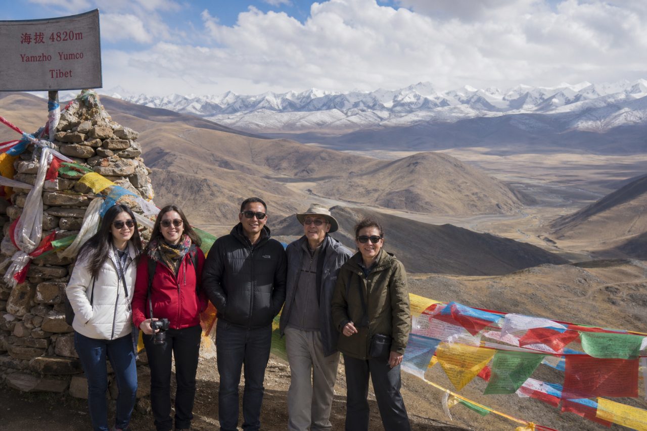 Travelers on a high-altitude roadside viewpoint above Yamdrok Lake during a 9-day Tibet tour